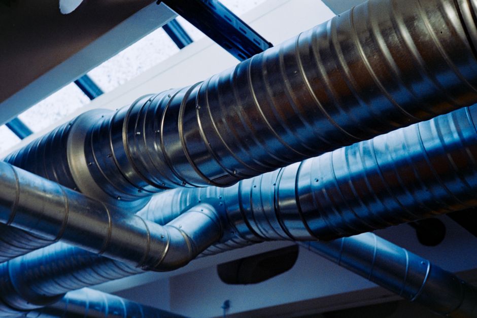HVAC technicians installing a new outdoor air conditioner unit at a home