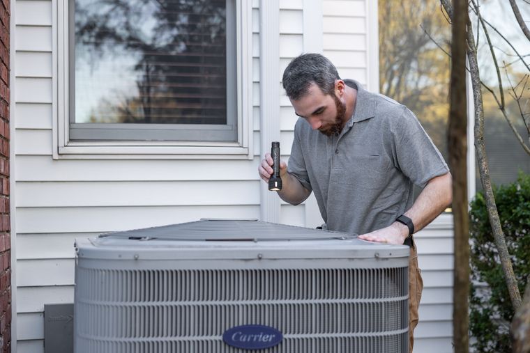 AC Repair showing an HVAC technician servicing outdoor equipment