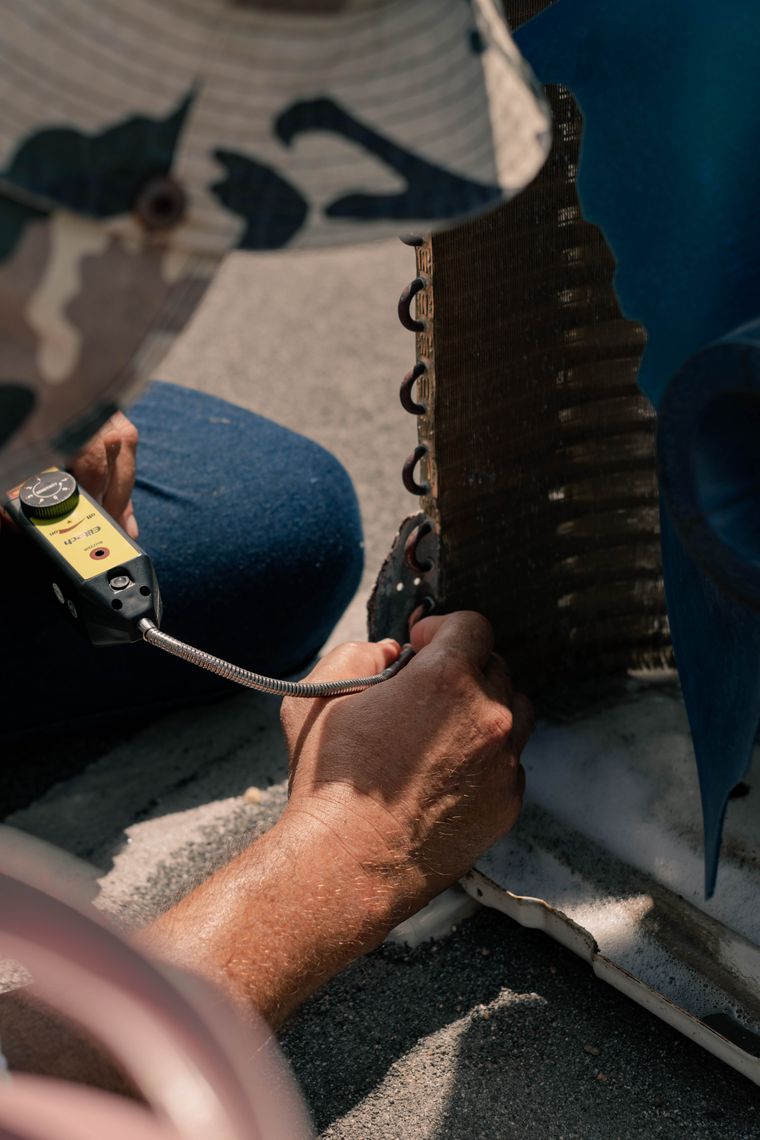 AC Repair showing an outdoor air conditioner inspection